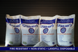 Bags of granular absorbent lined up with a pile of material in front of the bags against a dark background and a text ribbon that reads fire resistant, non-static, landfill disposable.