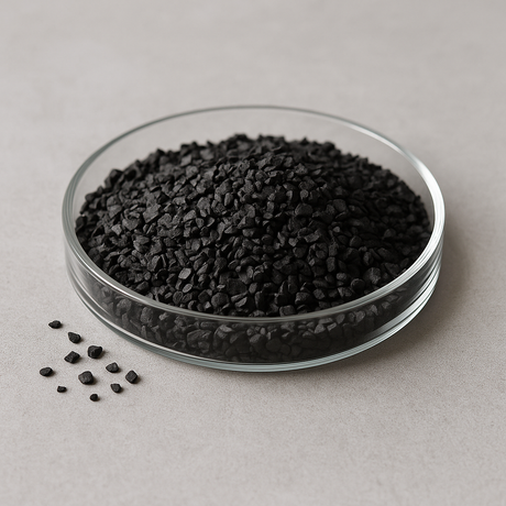 Coconut-shell granular activated carbon (8×30 mesh) in a glass dish on a neutral lab surface