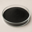 Food-grade powdered activated carbon 80×325, acid-washed coconut, fine black powder in a petri dish