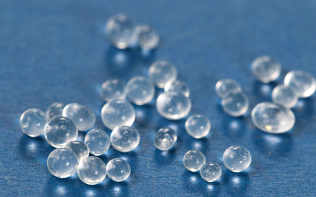 Clear desiccant beads on blue background 