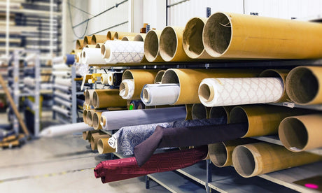 Shelf of various textile patterns and fabrics in a processing facility 
