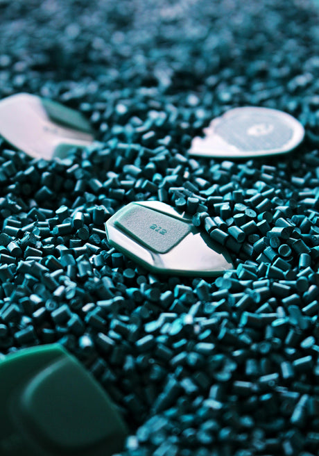 A dark green pile of plastic beads produced from polymer with the aid of sorbents