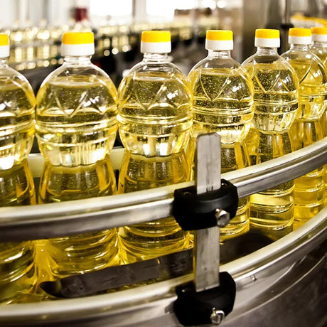 View of filtered cooking oil on bottling line. 