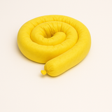 Coiled yellow hazmat absorbent sock, 3 inches by 48 inches, for acids, bases, and hazardous chemical spill containment in industrial and laboratory settings.