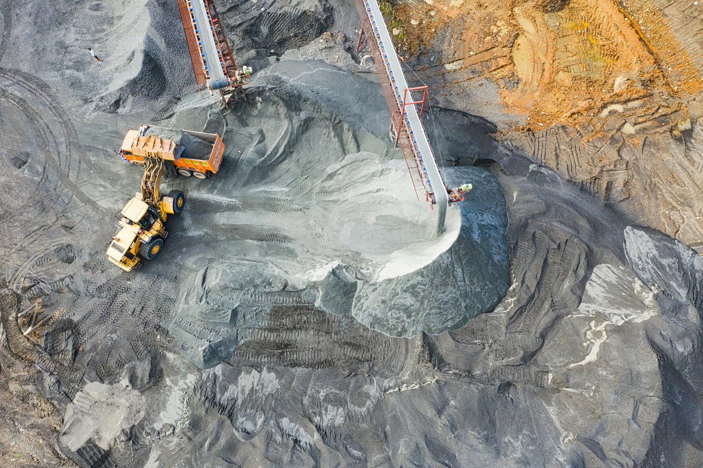 Birdseye view of mining operation with a truck and machinery in a quarry