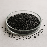 Coal-based granular activated carbon (8×30 mesh) in a glass dish on a neutral background