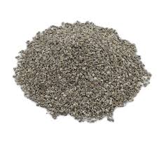 Granular grey absorbent material piled on a white background, resembling clay-based sorbent