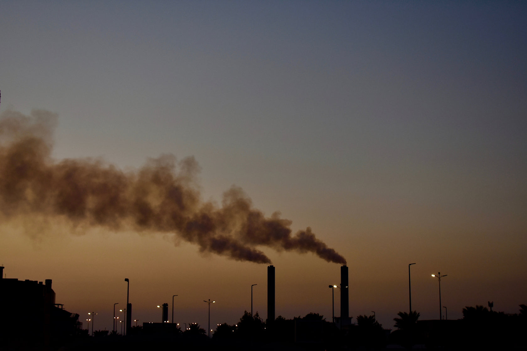 Industrial towers billowing smoke 